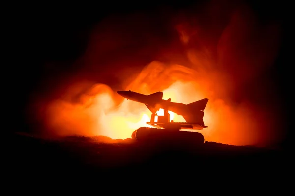 Rocket launch with fire clouds. Battle scene with rocket Missiles with Warhead Aimed at Gloomy Sky at night. Rocket vehicle on War Backgound. Selective focus