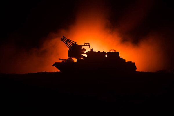 Sea battle scene. Silhouette of military war ship on dark foggy toned sky background. Dramatic war scene with Explosion and fire as decoration. Selective focus