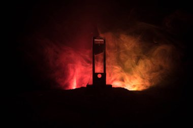 Horror view of Guillotine. Close-up of a guillotine on a dark foggy background. Execution concept clipart
