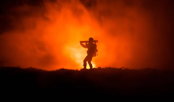 Military soldier silhouette with bazooka. War Concept. Military silhouettes fighting scene on war fog sky background, Soldier Silhouette aiming to the target at night. Attack scene