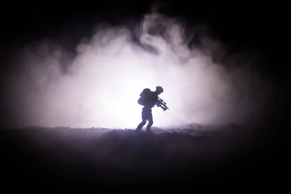 Military soldier silhouette with gun. War Concept. Military silhouettes fighting scene on war fog sky background, World War Soldier Silhouette Below Cloudy Skyline At night. Attack scene