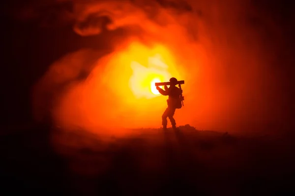 Military soldier silhouette with bazooka. War Concept. Military silhouettes fighting scene on war fog sky background, Soldier Silhouette aiming to the target at night. Attack scene