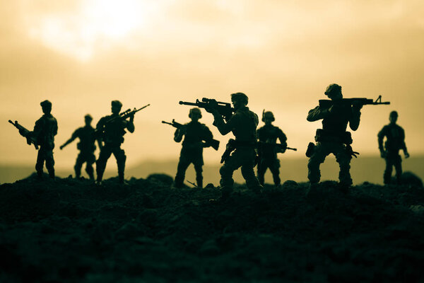 Battle scene. Military silhouettes fighting scene on war fog sky background. World War Soldiers Silhouettes Below Cloudy Skyline At sunset. Artwork Decoration. Selective focus