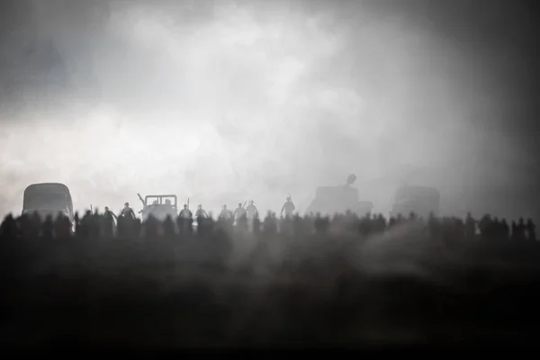 Captured by enemy concept. Military silhouettes and crowd on war fog sky background. World War Soldiers and armored vehicles movement while scared people watching. Artwork decoration. Selective focus