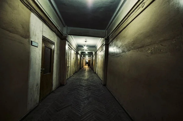 Dark corridor. Mystical interior of dark empty corridor, tunnel in an abandoned house. Dark mysterious corridor. The interior of an abandoned house, road to hell. An old abandoned building