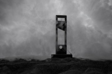 Horror view of Guillotine. Close-up of a guillotine on a dark foggy background. Execution concept clipart