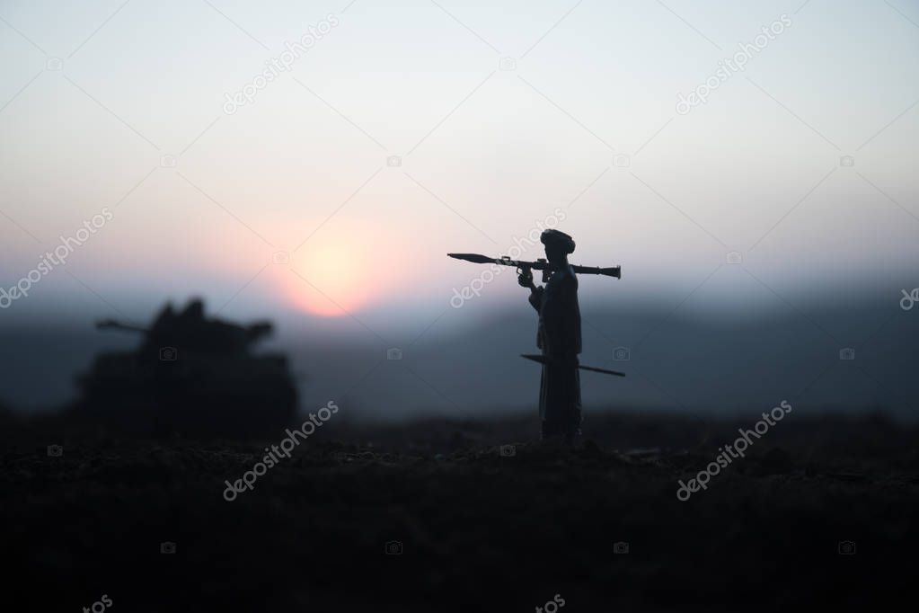Military soldier silhouette with bazooka. War Concept. Military silhouettes fighting scene on war fog sky background, Soldier Silhouette aiming to the target at sunset. Attack scene