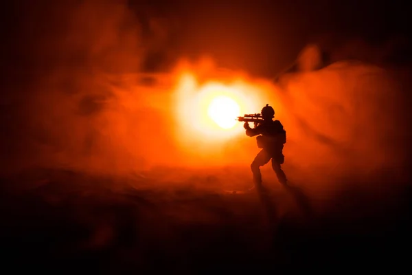 Military soldier silhouette with gun. War Concept. Military silhouettes fighting scene on war fog sky background, World War Soldier Silhouette Below Cloudy Skyline At night. Attack scene