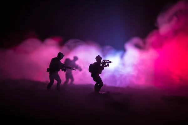 Military soldier silhouette with gun. War Concept. Military silhouettes fighting scene on war fog sky background, World War Soldier Silhouette Below Cloudy Skyline At night. Attack scene