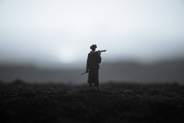 Military soldier silhouette with bazooka. War Concept. Military silhouettes fighting scene on war fog sky background, Soldier Silhouette aiming to the target at sunset. Attack scene