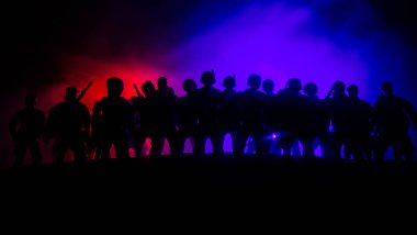 Anti-riot police give signal to be ready. Government power concept. Police in action. Smoke on a dark background with lights. Blue red flashing sirens. Dictatorship power clipart