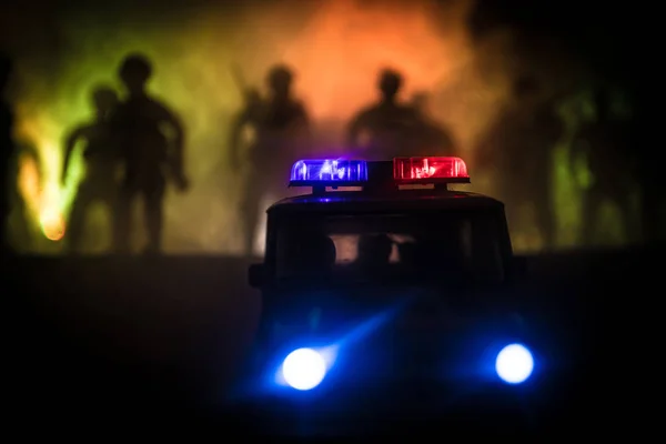 Police cars at night. Police car chasing a car at night with fog background. 911 Emergency response police car speeding to scene of crime. Selective focus