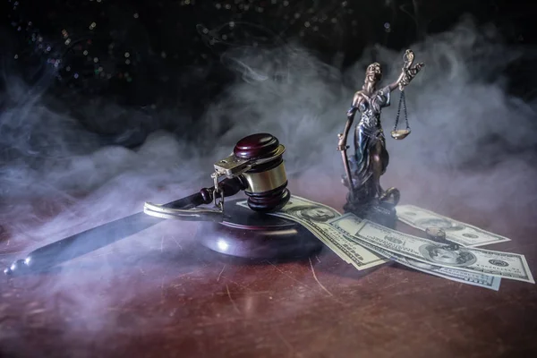 Law theme, mallet of the judge on wooden desk with Lady Justice Statue. Concept For Corruption, Justice, Law, Bankruptcy Court, Bail, Crime, Bribing, Fraud. Law gavel with handcuff and money