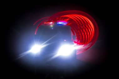 Geceleri polis arabaları. Polis arabası sisli bir arabayı gece takip ediyor. 911 acil durum arabası suç mahalline doğru hızla gidiyor. Seçici odak