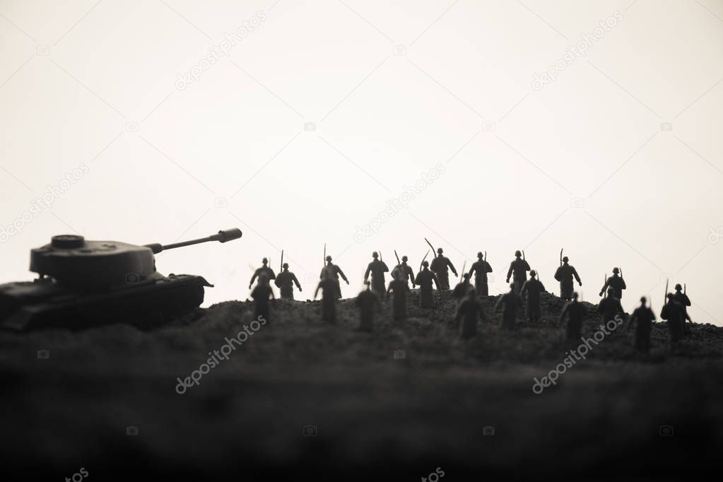 War Concept. Military silhouettes fighting scene on war fog sky background, World War Soldiers Silhouettes below Cloudy Skyline at sunset. Attack scene. Armored vehicles.