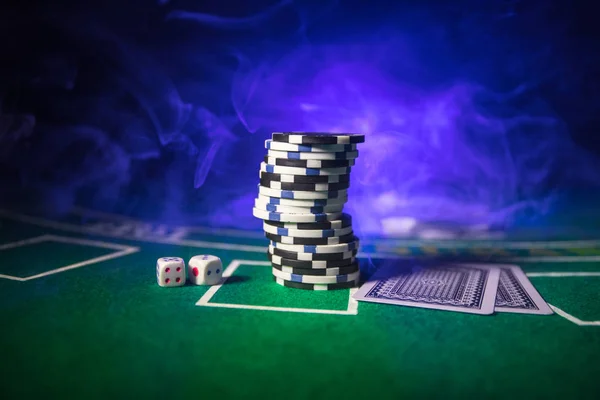 Cards and chips on green felt casino table. Abstract background with copy space. Gambling, poker, casino and cards games theme. Casino elements on green. Selective focus