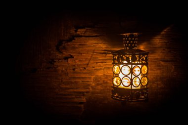 İslami bayram için gece mumlu Arap feneri. Müslüman kutsal Ramazan ayı. Bayram ve Mutlu Yıllar 'ın sonu. Boşluğu koyu arkaplanda kopyala.