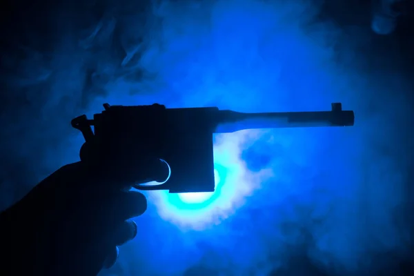 Male Hand Holding Gun Black Background Smoke Toned Back Lights — Stock Photo, Image
