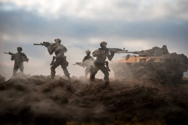 War Concept. Military silhouettes fighting scene on war fog sky background, World War Soldiers Silhouettes Below Cloudy Skyline at sunset. Attack scene. Armored vehicles.