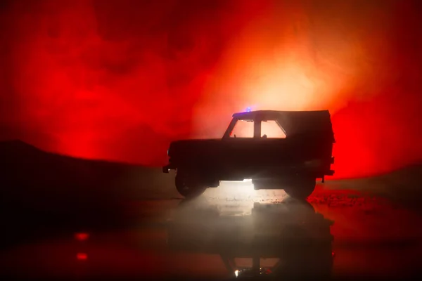 Police cars at night. Police car chasing a car at night with fog background. 911 Emergency response police car speeding to scene of crime. Selective focus