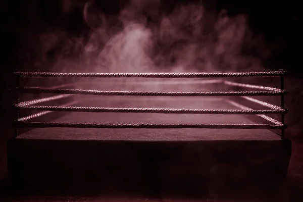 Empty boxing ring with red ropes for match in the stadium arena. Creative artwork decoration