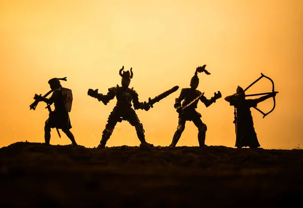 Medieval battle scene with cavalry and infantry. Silhouettes of figures as separate objects, fight between warriors on sunset foggy background. — Stock Photo, Image