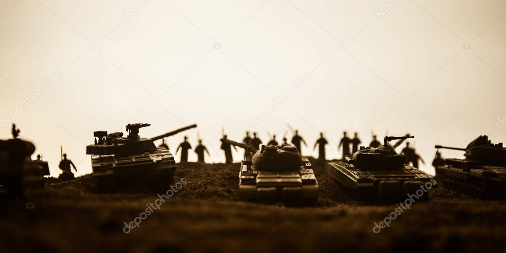 War Concept. Military silhouettes fighting scene on war fog sky background, World War Soldiers Silhouettes below Cloudy Skyline at sunset. Attack scene. Armored vehicles.