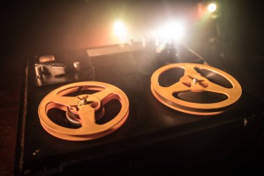 Koyu tonda sisli arka plan üzerinde makara oynatıcı ve kaydedici eski vintage makara. Analog Stereo Açık Makara Bant Güverte Kaydedici Çalar Makaralar ile. Seçici odaklama