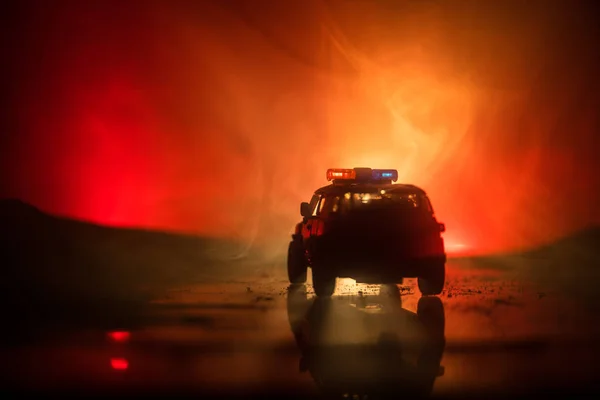 Police cars at night. Police car chasing a car at night with fog background. 911 Emergency response