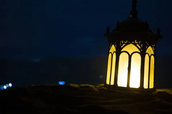 Ornamental Arabic lantern with burning candle glowing at night. Festive greeting card, invitation for Muslim holy month Ramadan Kareem. — Stock Photo, Image