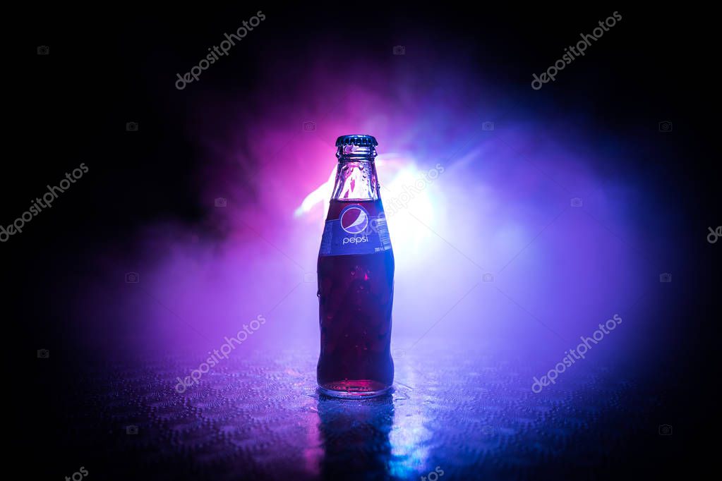 BAKU, AZERBAIJAN -APRIL 20,2019 : Pepsi Classic in a glass bottle against dark toned foggy background. Pepsi is a carbonated soft drink produced by PepsiCo.