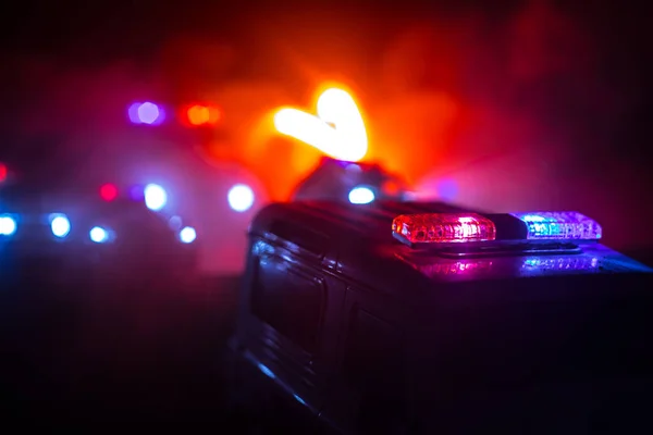 Police cars at night. Police car chasing a car at night with fog background. 911 Emergency response pSelective focus — Stock Photo, Image