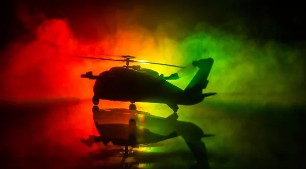 Askeri helikopter çatışma bölgesinden uçmaya hazır silüeti. Gece görüntüleri çöl sisli tonda sırt ile başlayarak helikopter ile dekore edilmiştir. Seçici odak. — Stok fotoğraf