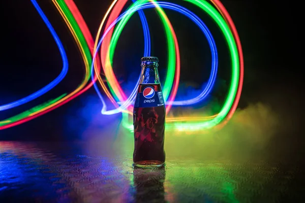 BAKU, AZERBAIJAN -APRIL 20,2019 : Pepsi Classic in a glass bottle against dark toned foggy background. Pepsi is a carbonated soft drink — Stock Photo, Image