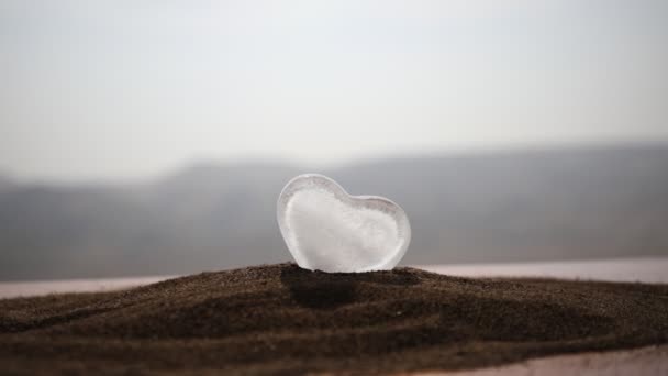 Corazón de cristal abstracto en la nieve por la noche. Tarjeta para un día de San Valentín. Perdóname, te extraño te encantan las palabras de color rojo o gris. selectivo — Vídeo de stock