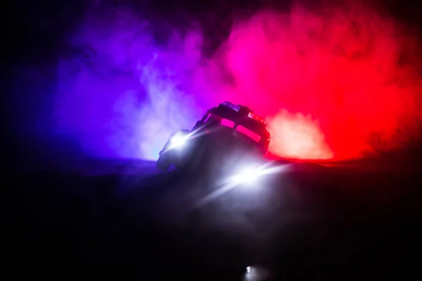 Police cars at night. Police car chasing a car at night with fog background. 911 Emergency response