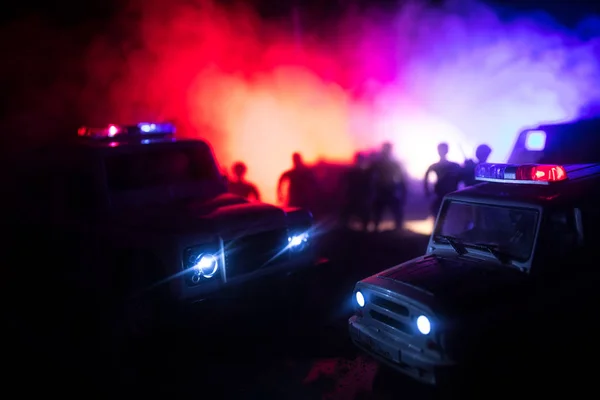 Police cars at night. Police car chasing a car at night with fog background. 911 Emergency response pSelective focus