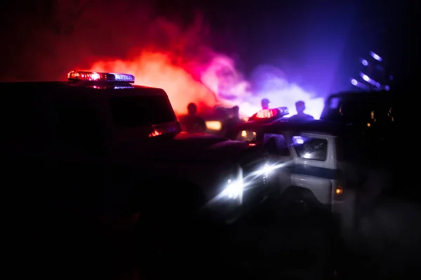 Police cars at night. Police car chasing a car at night with fog background. 911 Emergency response pSelective focus