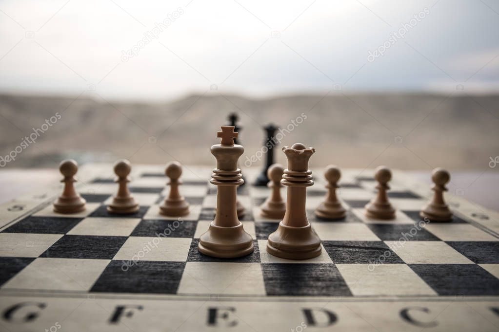 Chess board game concept of business ideas and competition. Chess figures on a chessboard. Outdoor sunset background.