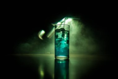 Kokteyl cam koyu tonda dumanlı arka plan veya cam renkli kokteyl sıçrayan. Parti kulübü eğlencesi. Karışık ışık.