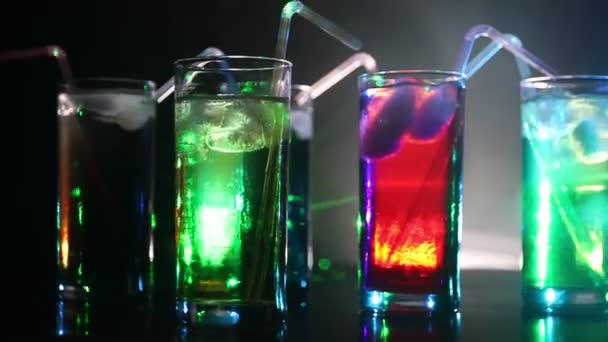 Cinque cocktail al bar con fumo su sfondo scuro. Occhiali di colore giallo, verde e blu . — Video Stock