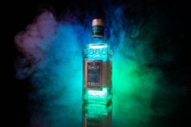 Bakü, Azerbaycan - 16 Haziran. 2019. Koyu tonda sisli arka plan üzerinde ahşap masa üzerinde Olmeca Tekila. Olmeca Tekila Jalisco, Meksika'da üretilen bir tekila.