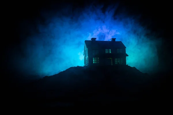 Casa velha com um fantasma na floresta à noite ou Abandonada Haunted Horror House no nevoeiro. Um velho edifício místico numa floresta de árvores mortas. Árvores à noite com lua. Luzes surreais . — Fotografia de Stock