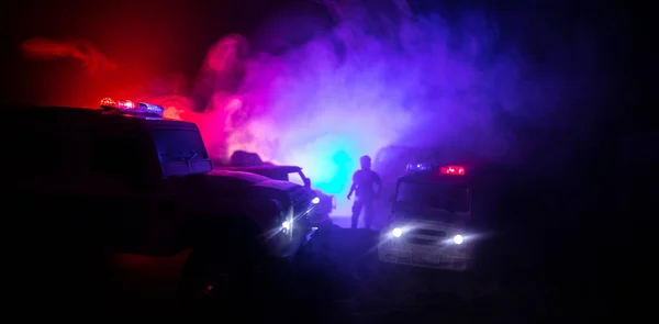 Police cars at night. Police car chasing a car at night with fog background. 911 Emergency response pSelective focus