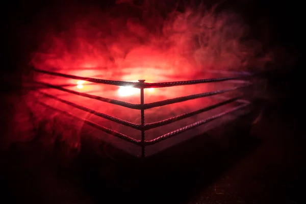 Empty boxing ring with red ropes for match in the stadium arena. Creative artwork decoration