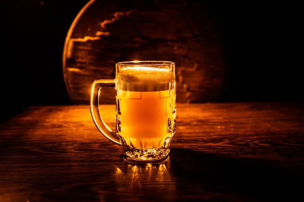 Creative concept. Beer glasses on wooden table at dark toned foggy background. — Stock Photo, Image