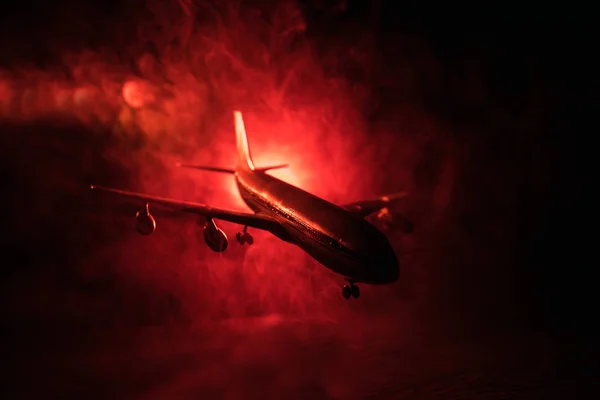 Artwork decoration. White passenger plane ready to taking off from airport runway. Silhouette of Aircraft during night time.