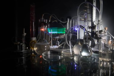Eczacılık ve kimya teması. Araştırma laboratuvarında solüsyon lu cam şişesi test edin. Bilim ve tıbbi geçmiş. Koyu tonlu arka plan üzerinde laboratuvar test tüpleri