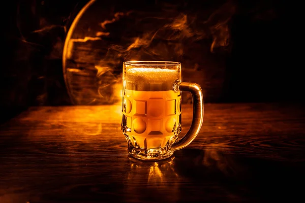 Creative concept. Beer glasses on wooden table at dark toned foggy background. — Stock Photo, Image