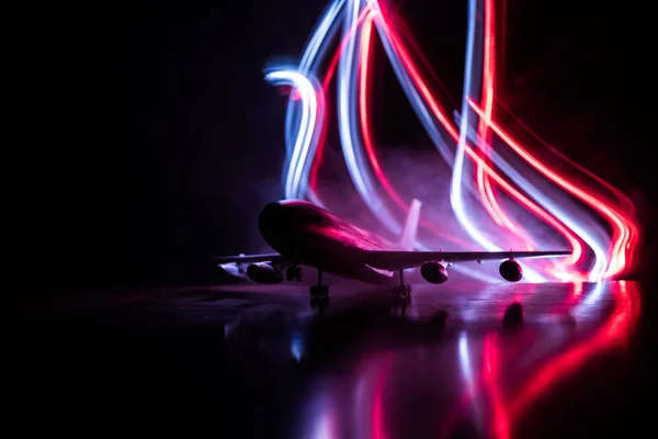 Artwork decoration. White passenger plane ready to taking off from airport runway. Silhouette of Aircraft during night time.